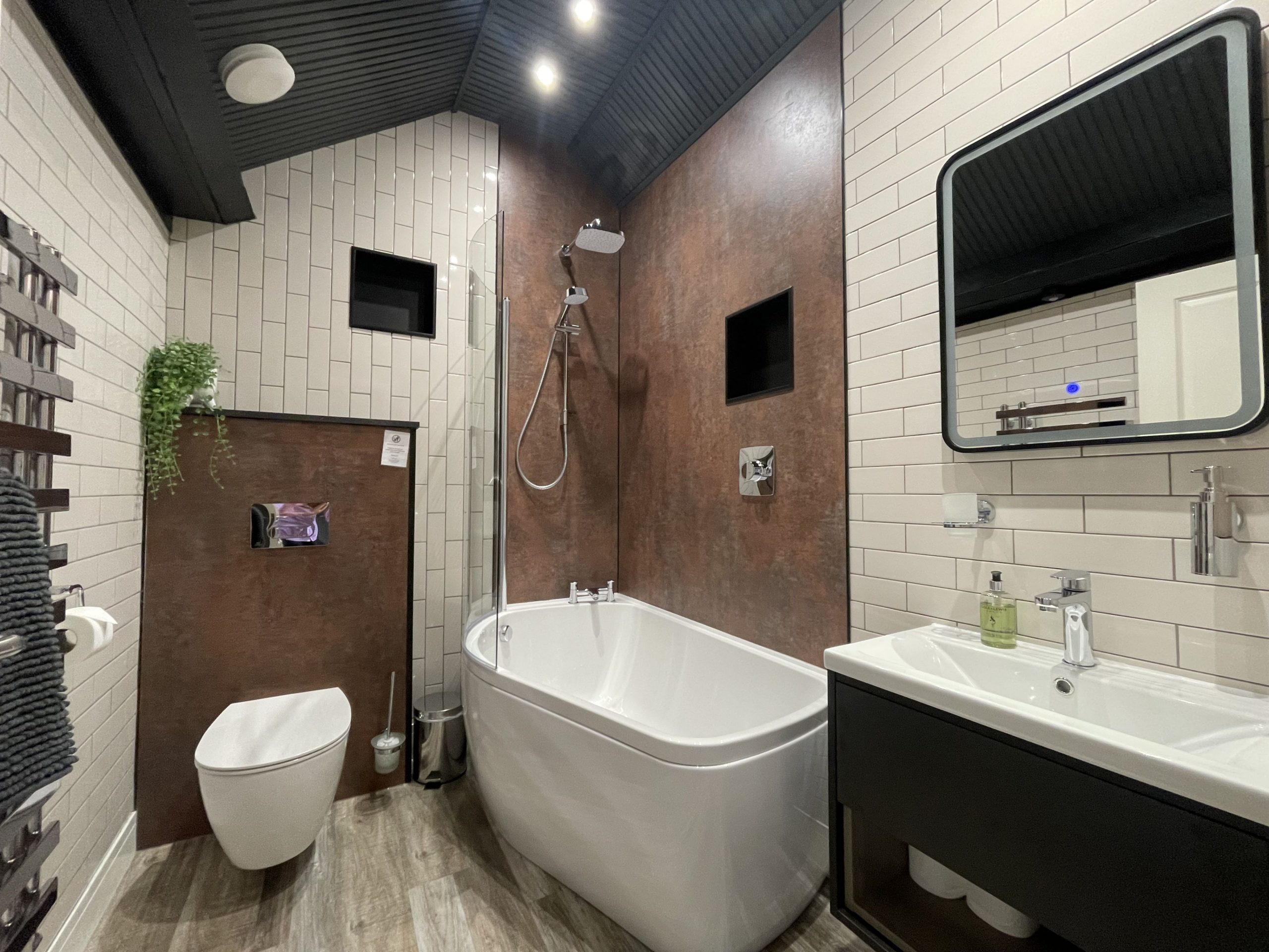 The recently fitted bathroom comprises bath and overhead shower