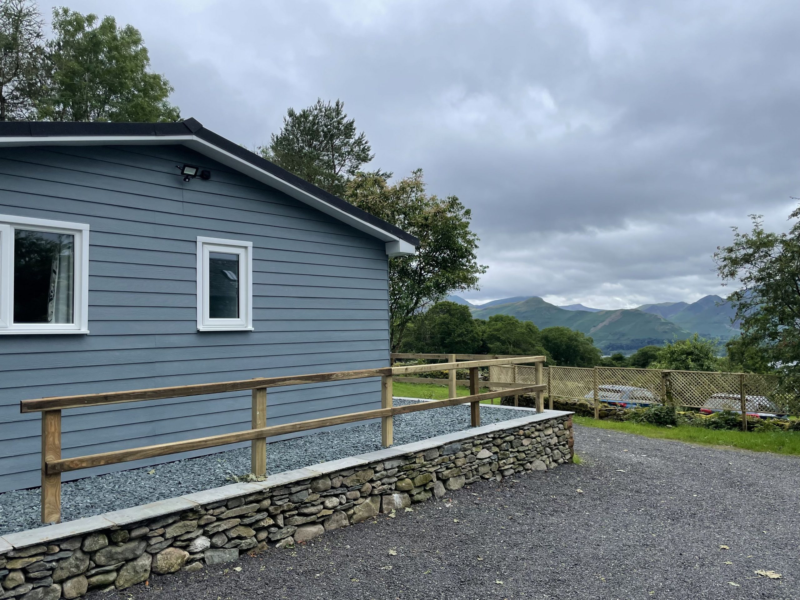 The lodge occupies an elevated position, looking out toward Derwentwater