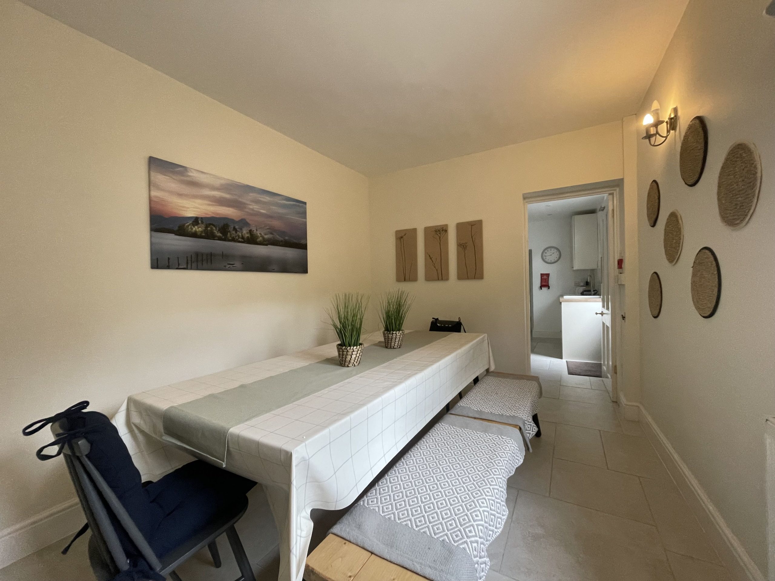 A spacious dining area features a large dining table seating 10 people