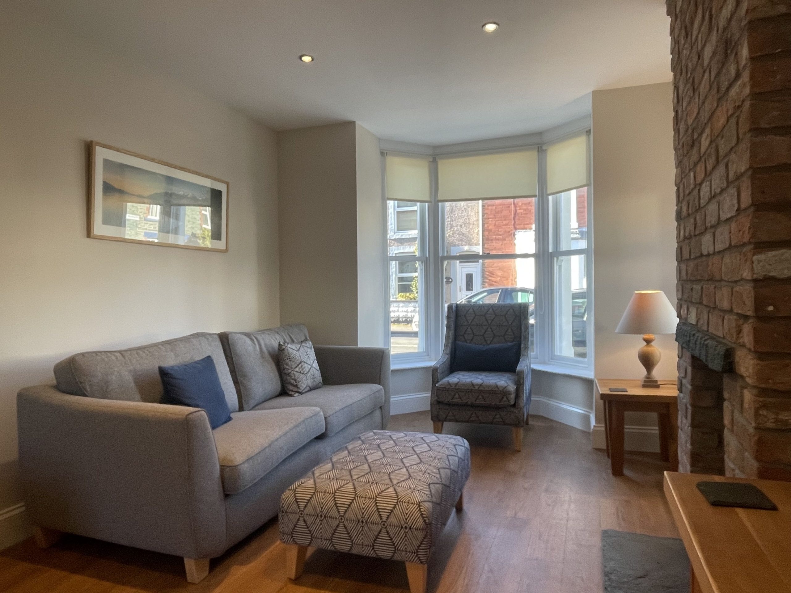 The living room features a log burning stove and bay window