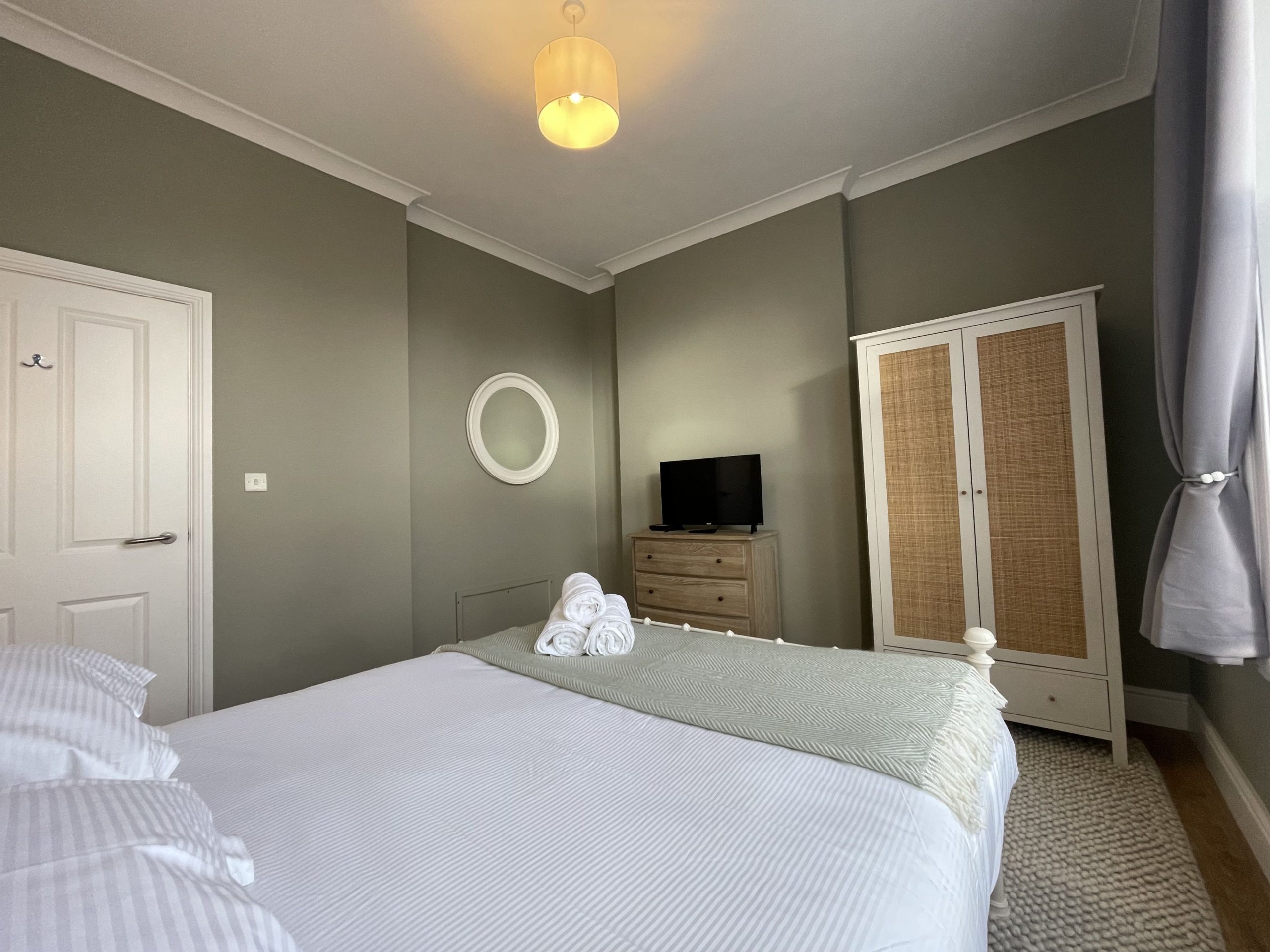 The master bedroom is also furnished with a wardrobe, chest of drawers, smart TV and bedside tables