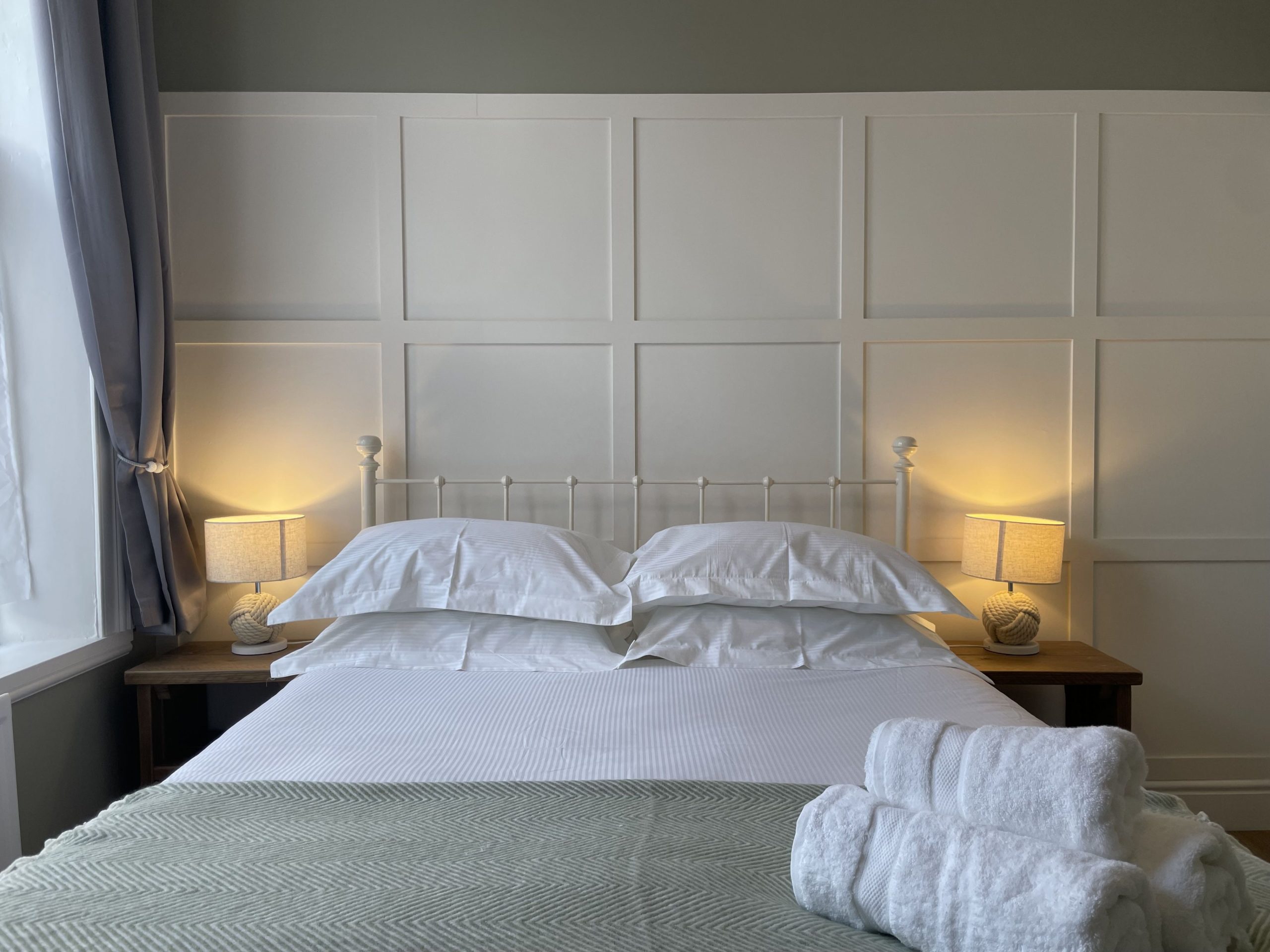 The bedroom is decorated beautifully with shaker panelling