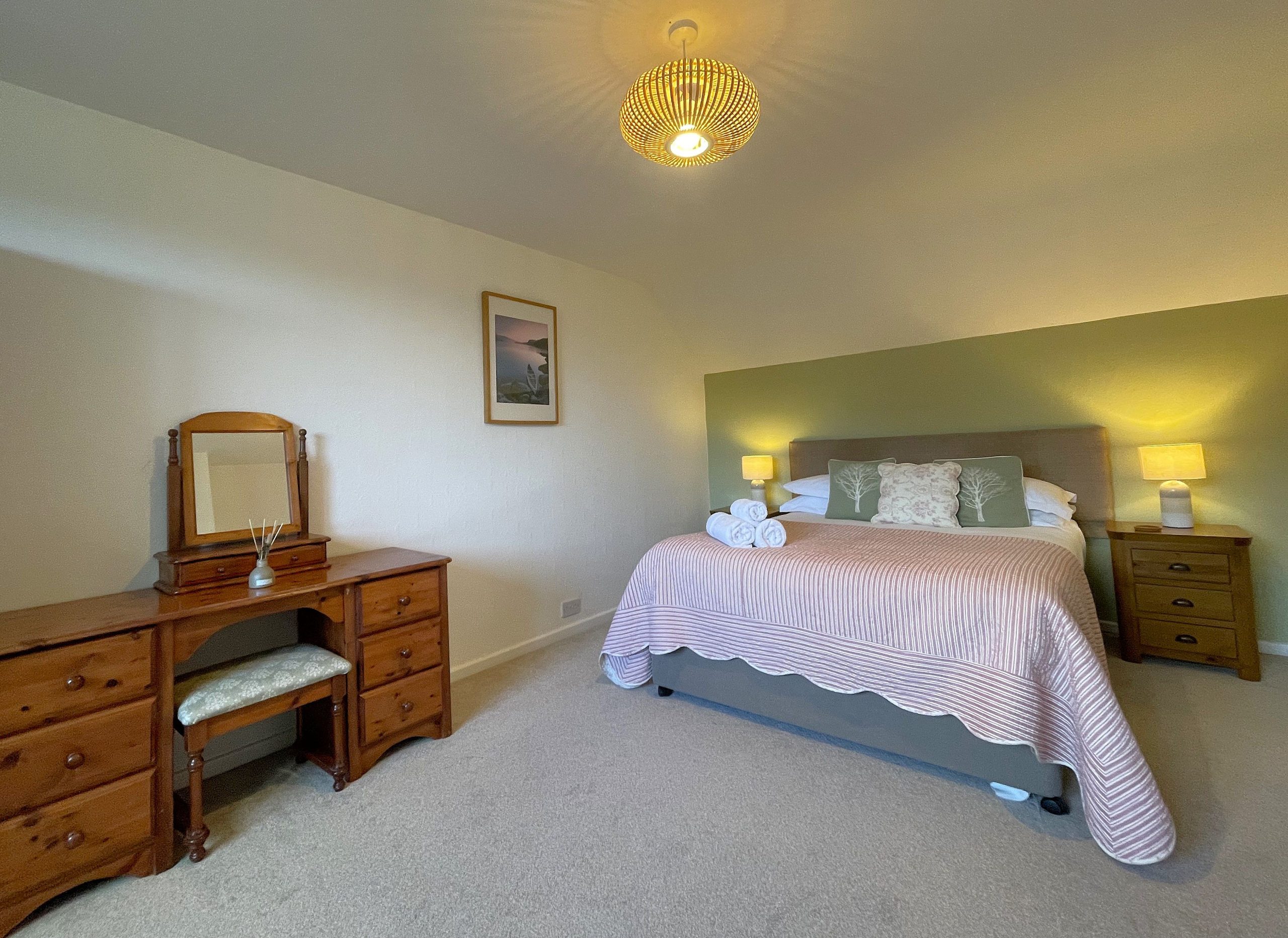The master bedroom consists of a comfortable king-size bed, wardrobe and dressing table.