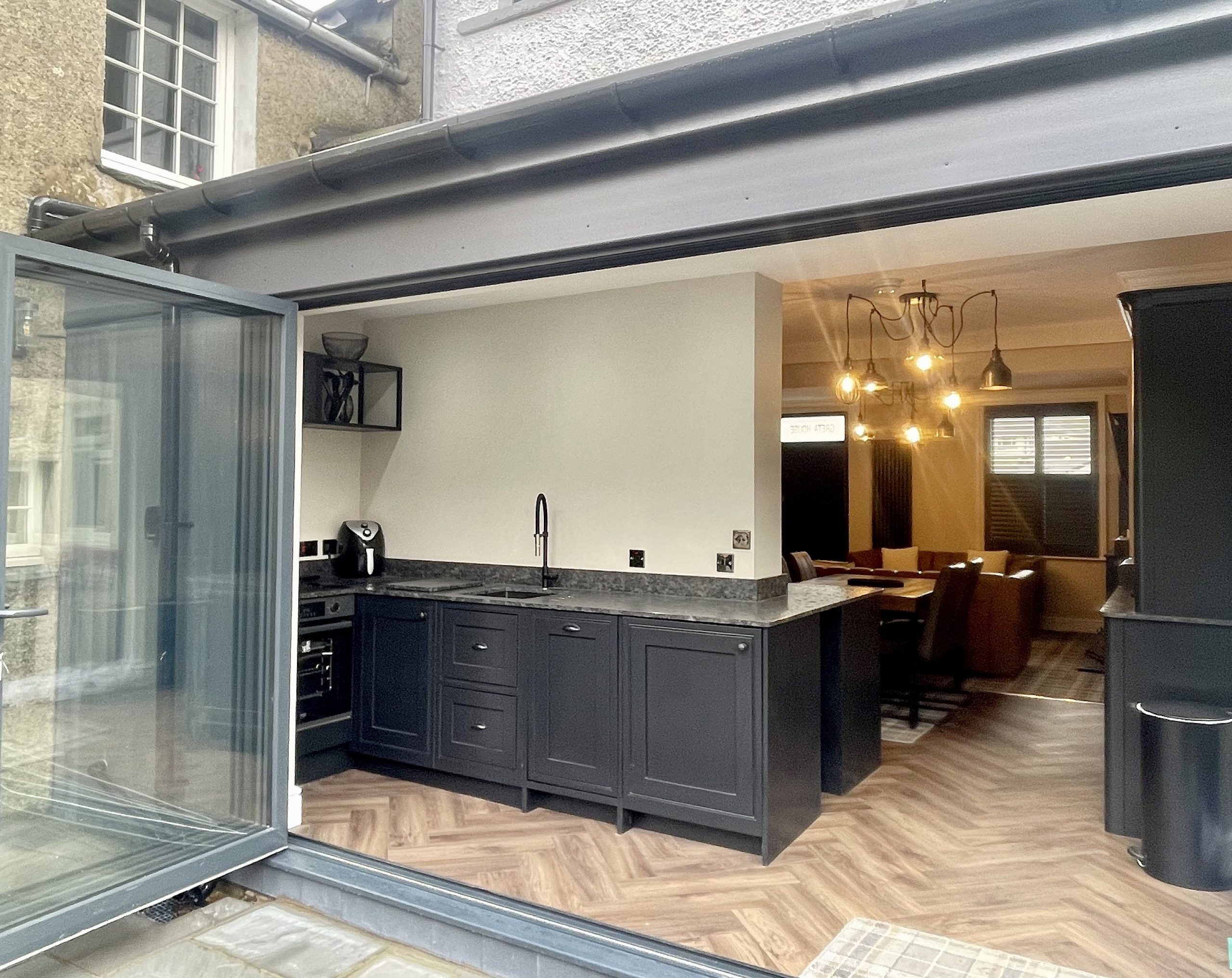 The kitchen is filled with light thanks to the bi-fold doors that open out onto the delightful patio area