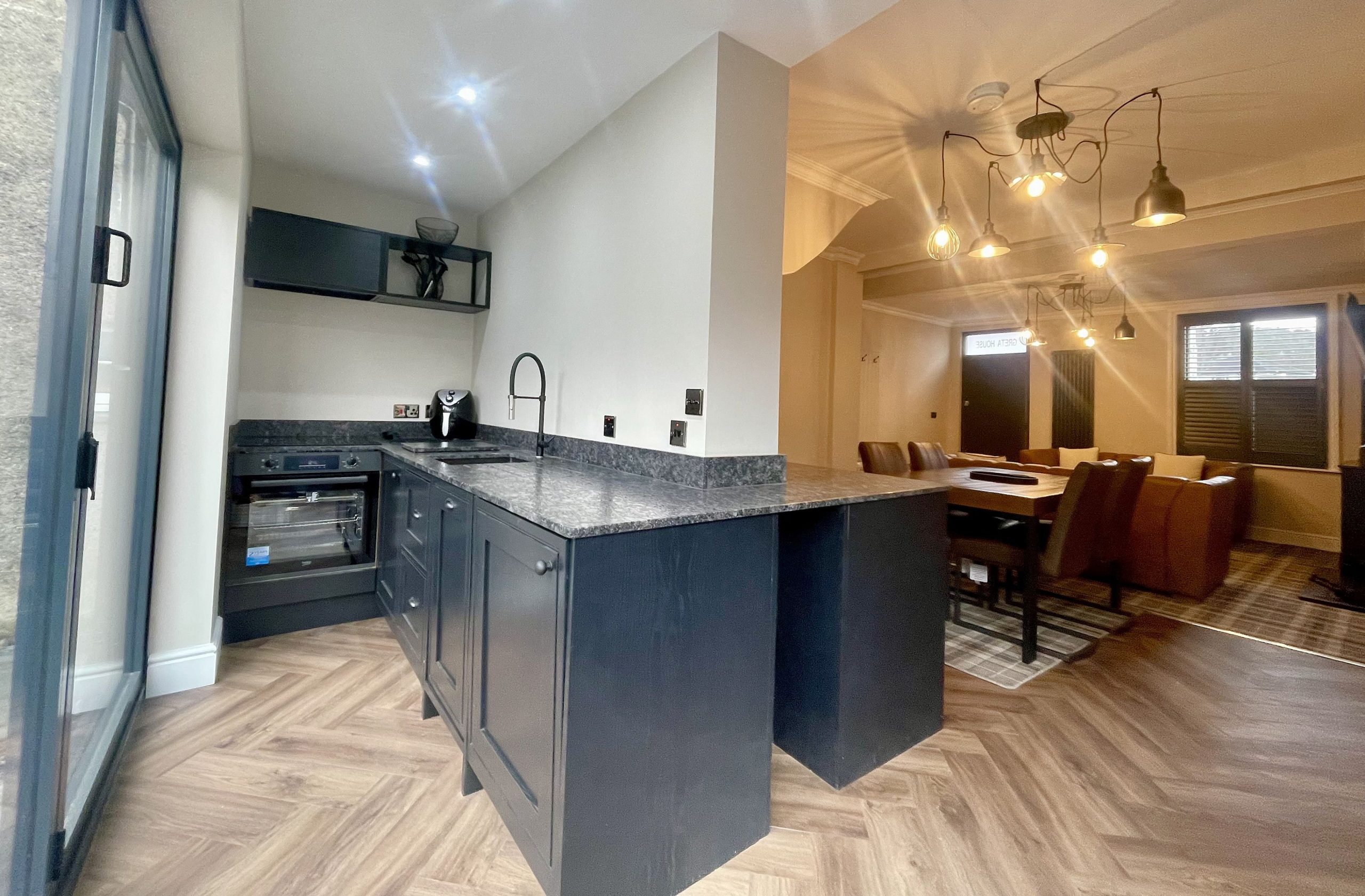 in the main kitchen area, which also houses the electric oven/grill, induction hob, dishwasher, sink with hose attachment, air-fryer and washer/dryer.