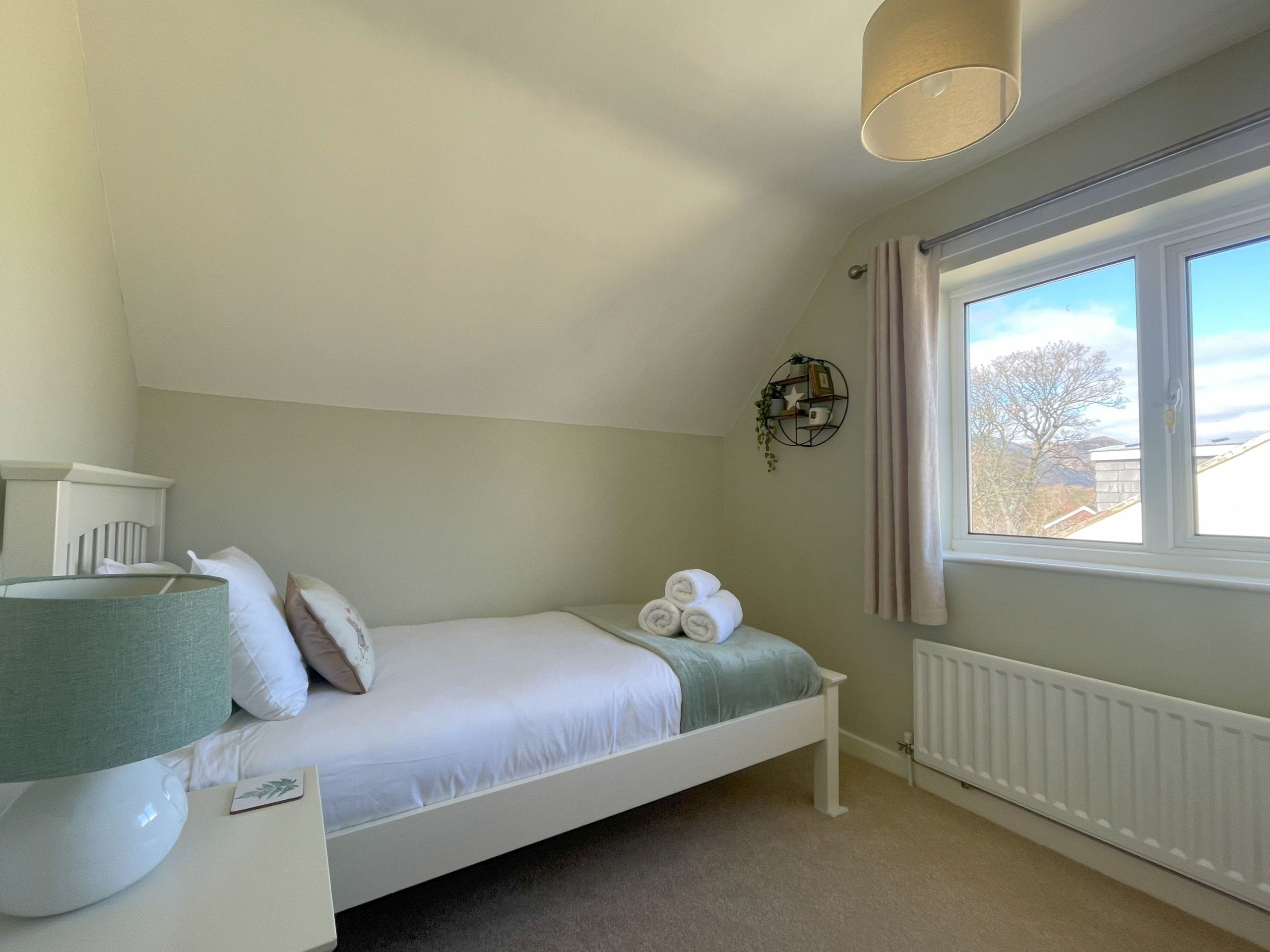 The cosy single bedroom has been decorated in calming colours