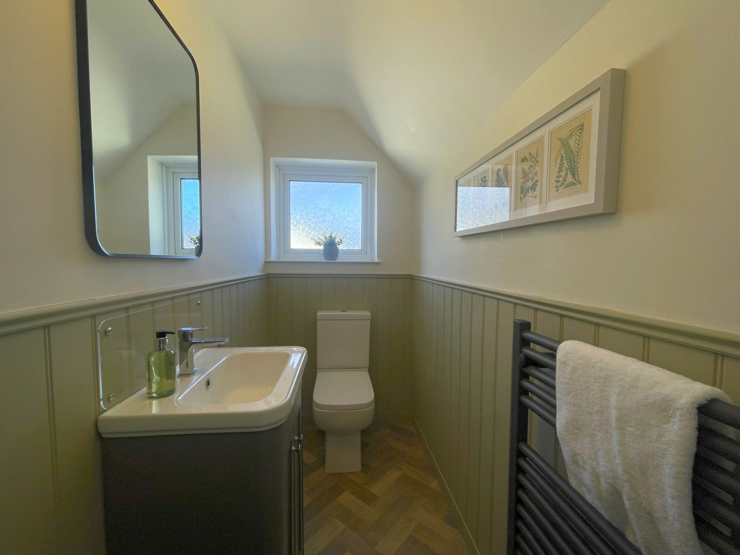 The upstairs toilet has been beautifully panelled for a modern feel