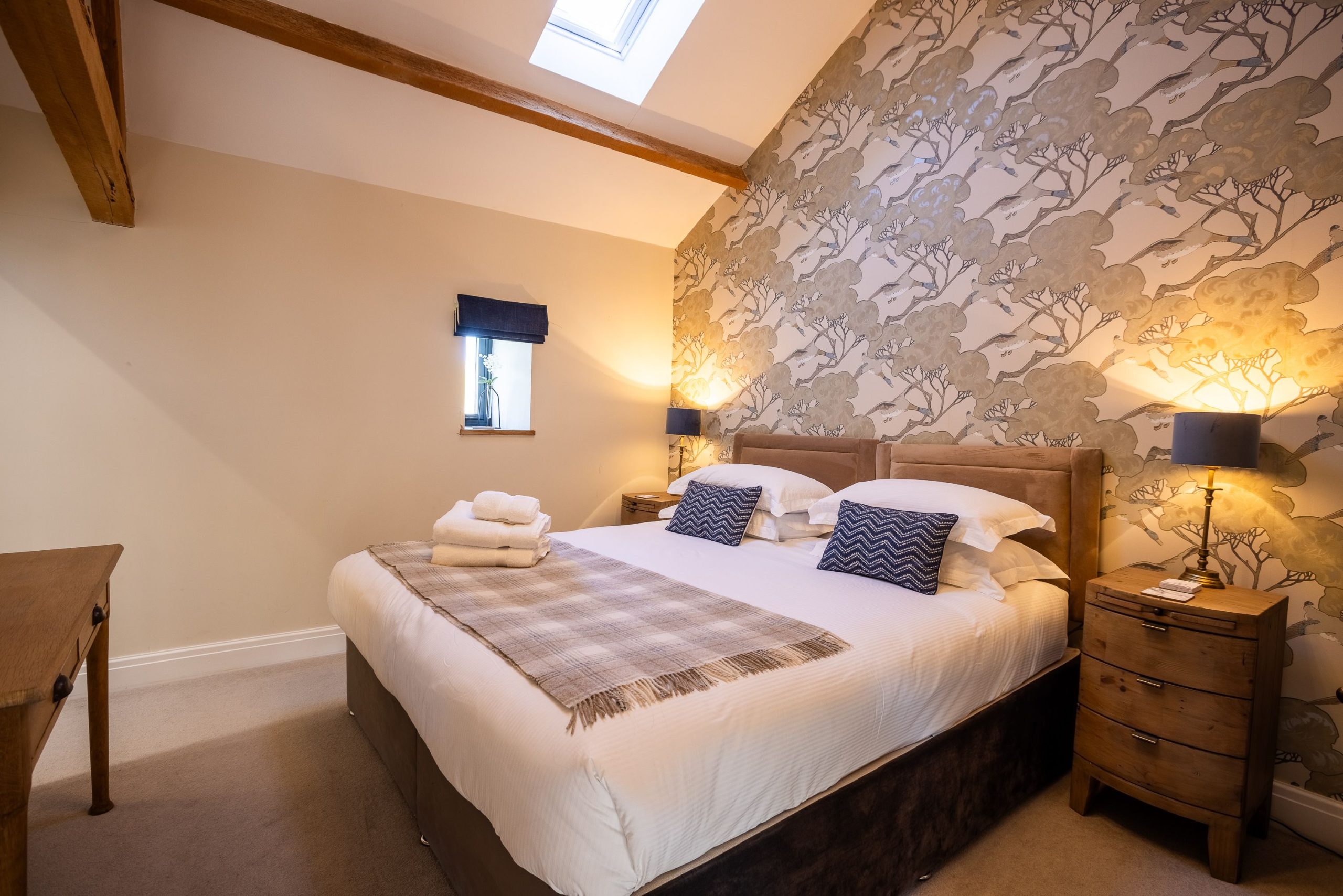 The upstairs bedrooms feature high ceilings and beams 