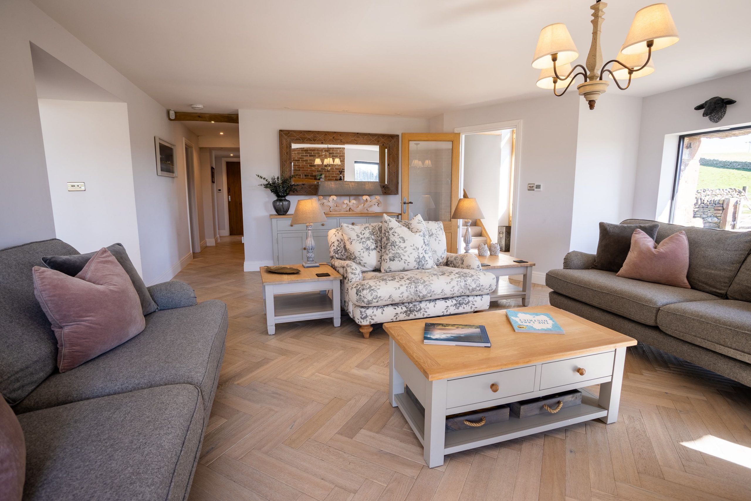  There is warm lighting, three plush sofas to curl up on, and a smart TV to enjoy your favourite show/film in the evenings.