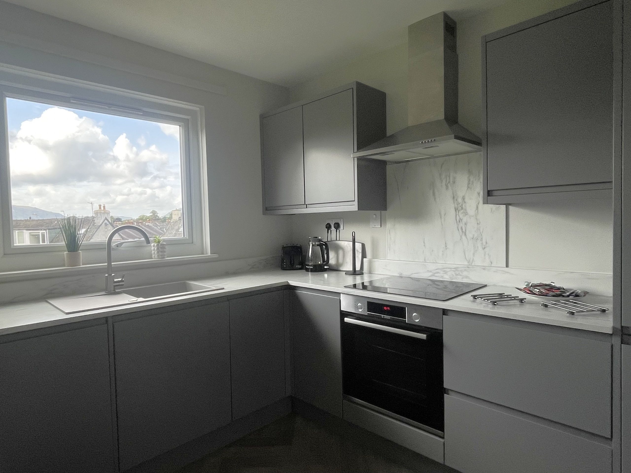 The kitchen is fitted with modern furnishings and facilities.