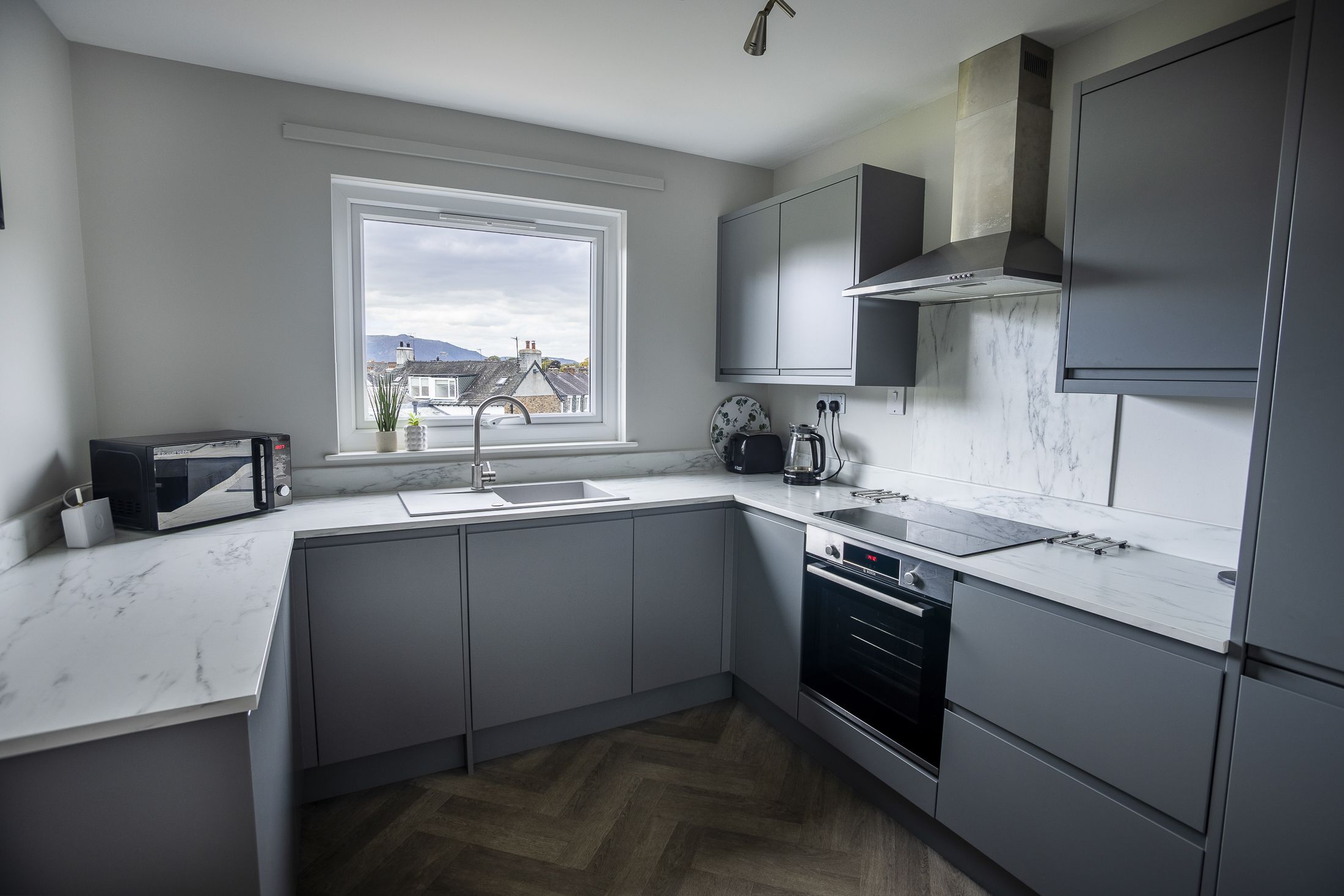 The kitchen is fitted with modern furnishings and facilities, perfect for self-catering.