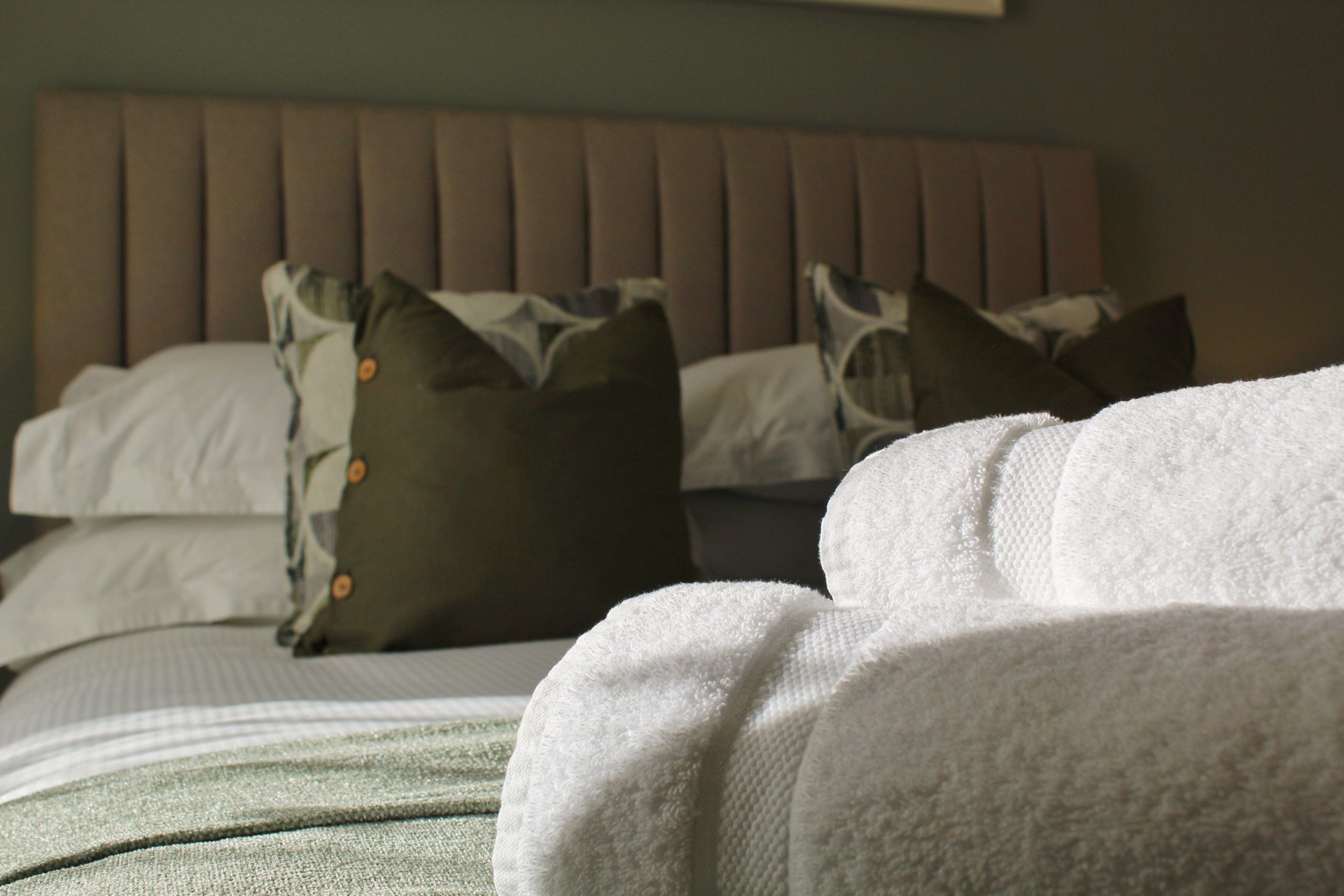 The master bedroom boasts an en-suite, with plush bedding and stylish decor.