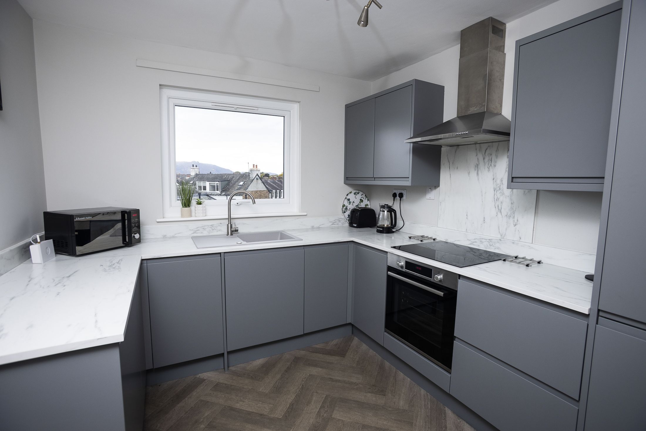 The kitchen is fitted with modern furnishings and facilities, perfect for self-catering.