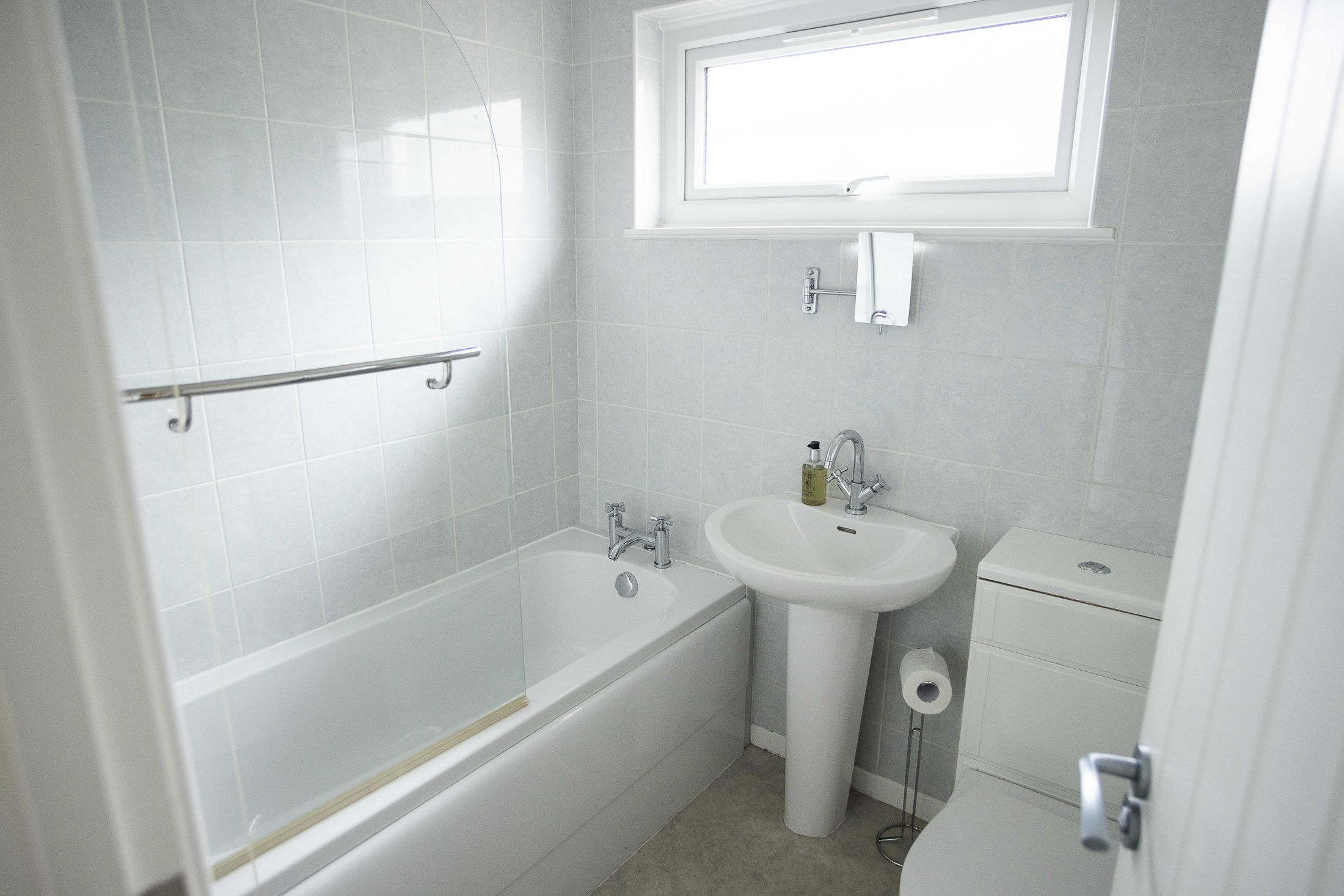 here is also a family bathroom with shower/bath, WC and sink