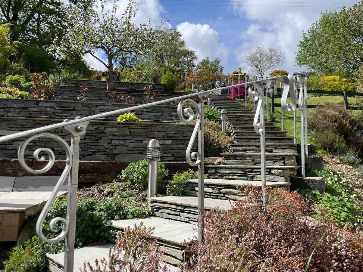The garden is beautifully landscaped, you an take the steps up to the elevated patio and enjoy the plants along the way