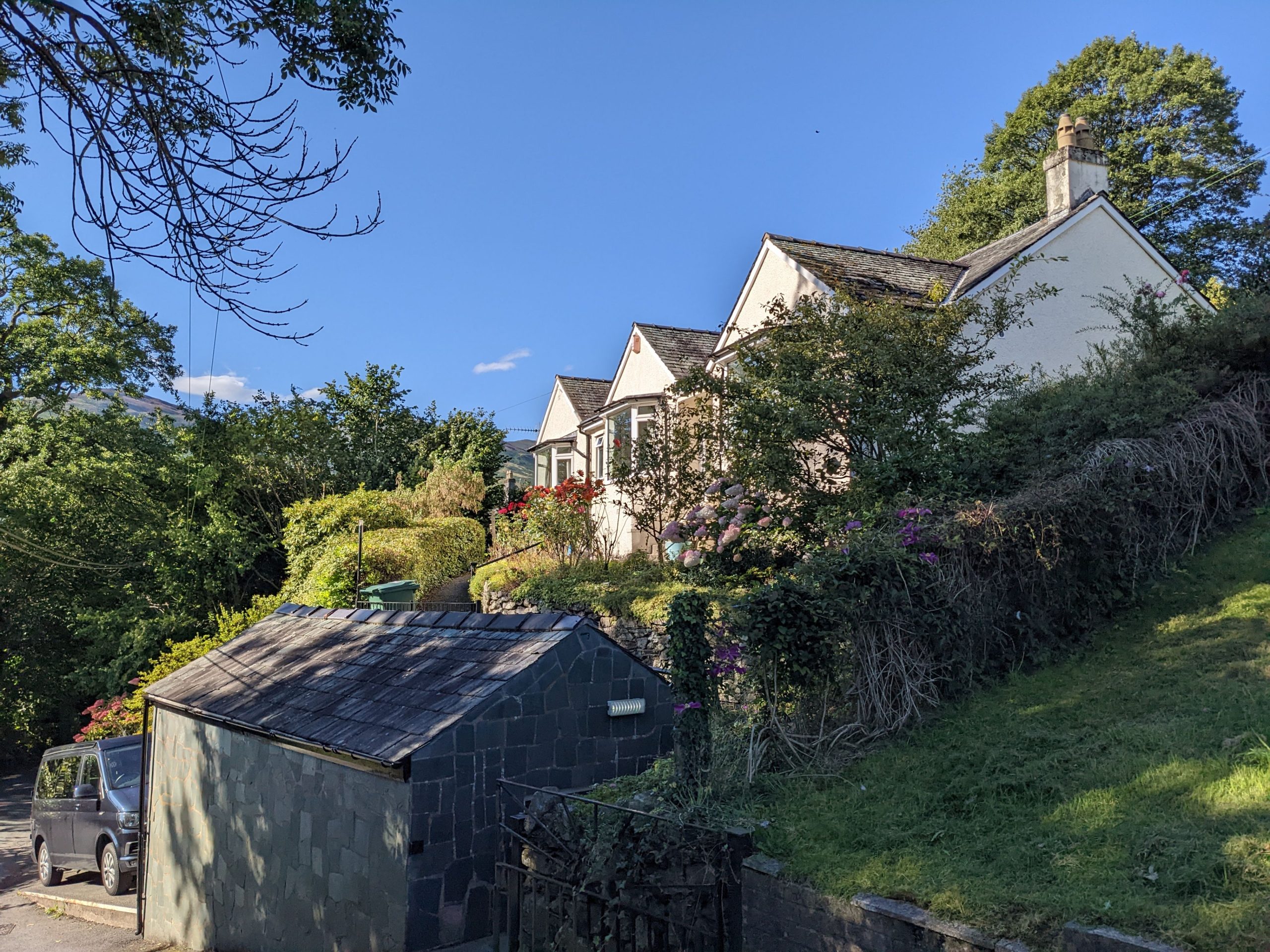 A view of Three Peaks from the road, you can see the garage and parking space in the bottom left corner