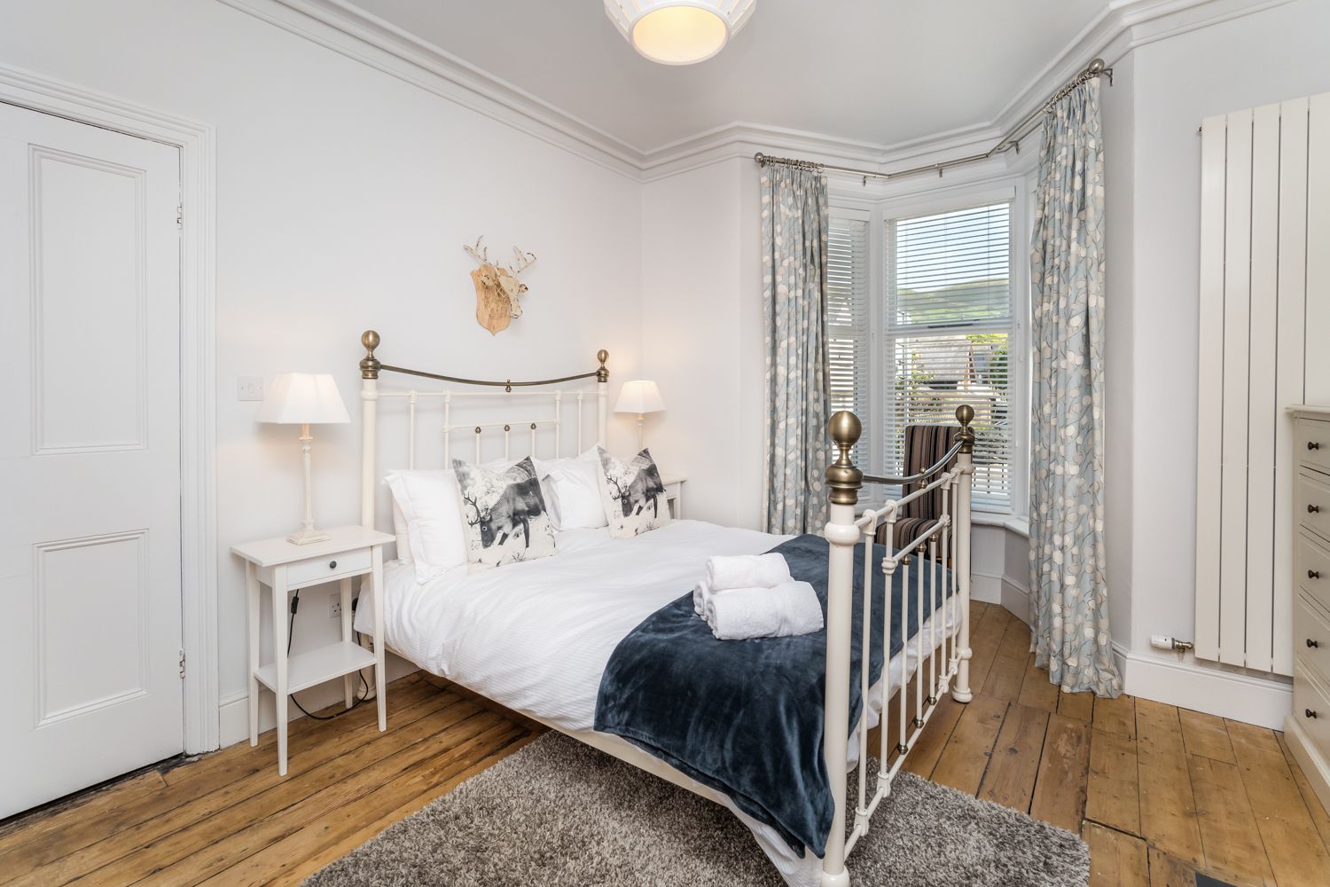 A delightful ground floor bedroom with bay window and king sized bed
