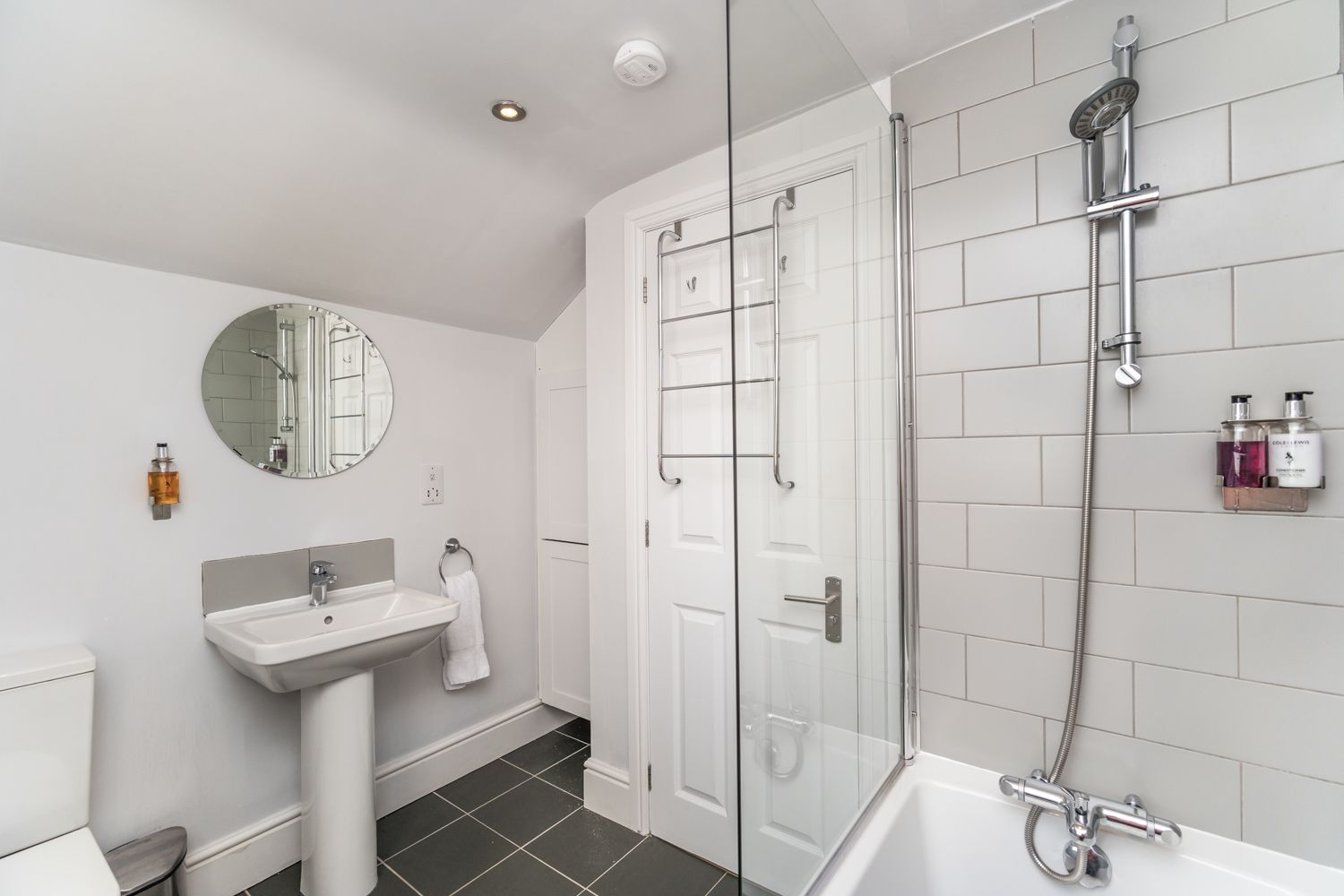 The bathroom comprises bath with overhead shower, hand sink and WC