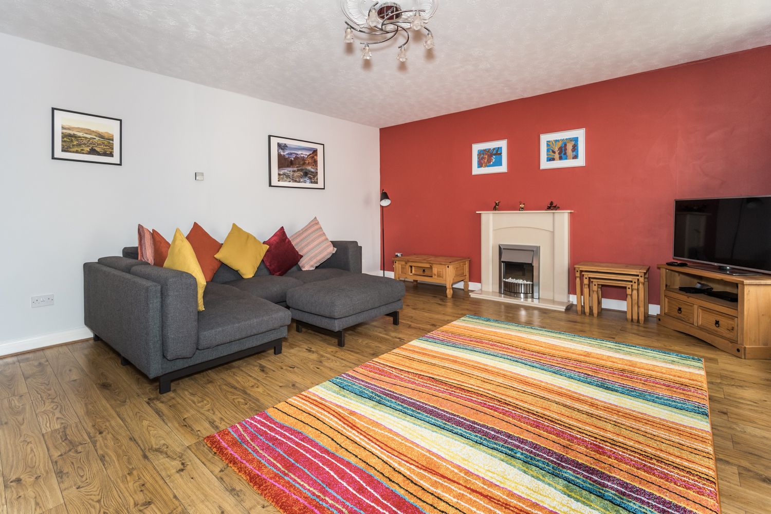 The light and bright living room features a large smart TV for guests to enjoy 