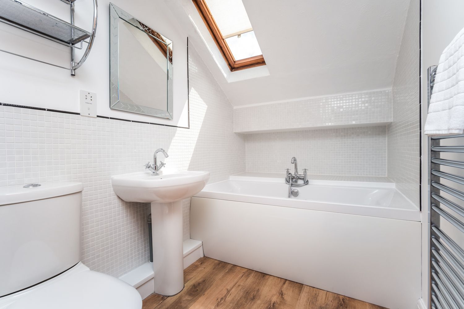 The family bathroom comprises bath with hand held shower, WC, hand sink and heated towel rail