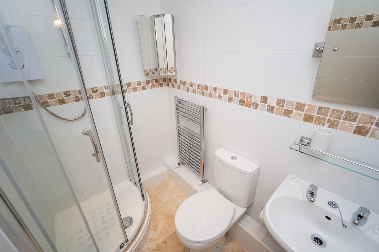 A beautiful ensuite bathroom comprising shower, WC and handbasin