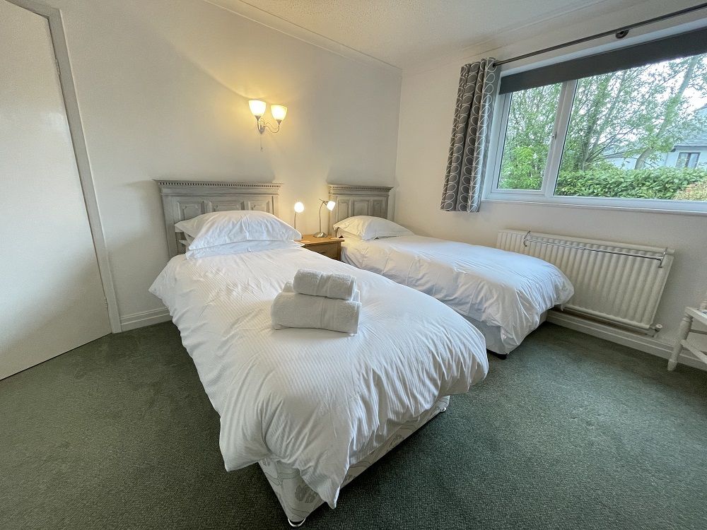 The second bedroom is a twin room with 2 single beds