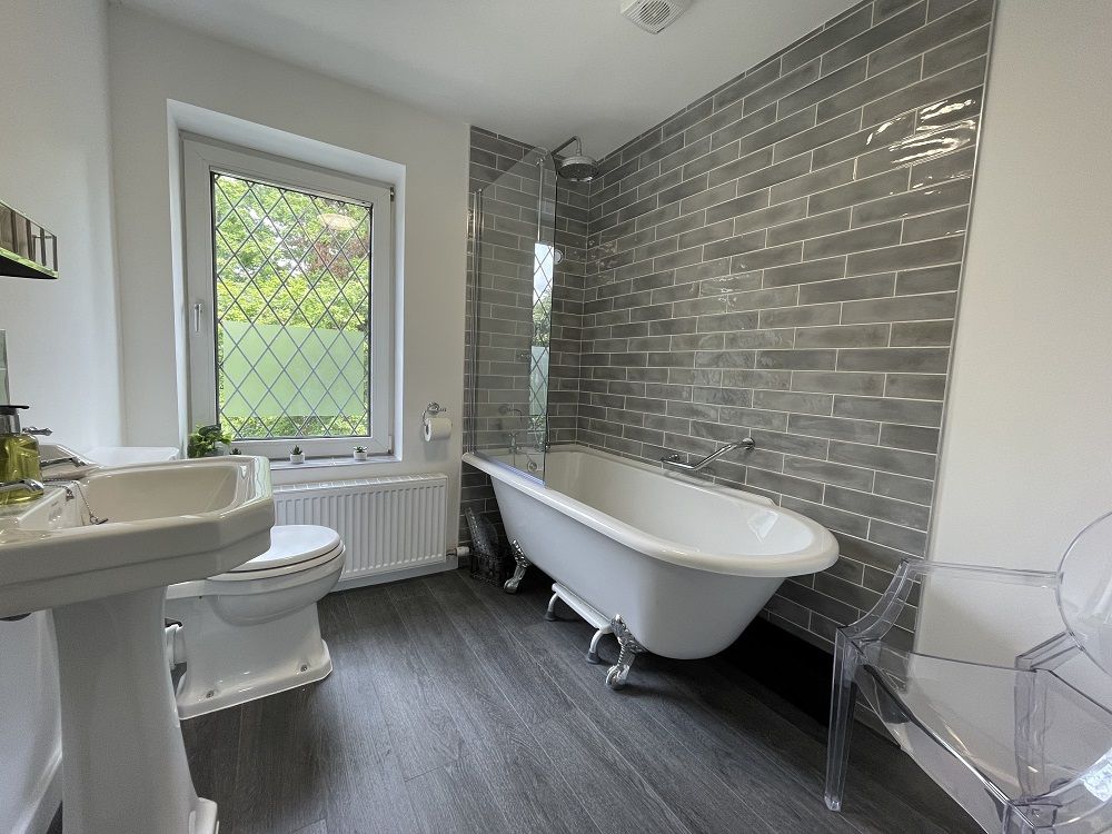 The beautiful bathroom features a bath, which weary walkers will love after a day in the fells!