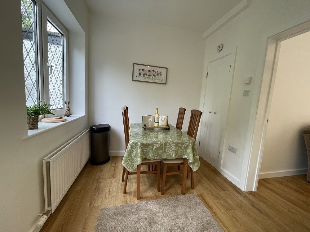 The solid wood table seating four is ideally placed for socialising with friends and family while preparing meals and cooking