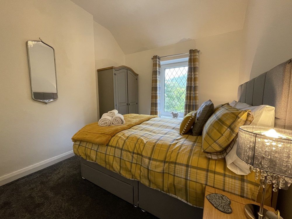 The master bedroom includes a double bed, wardrobe and bedside tables. 