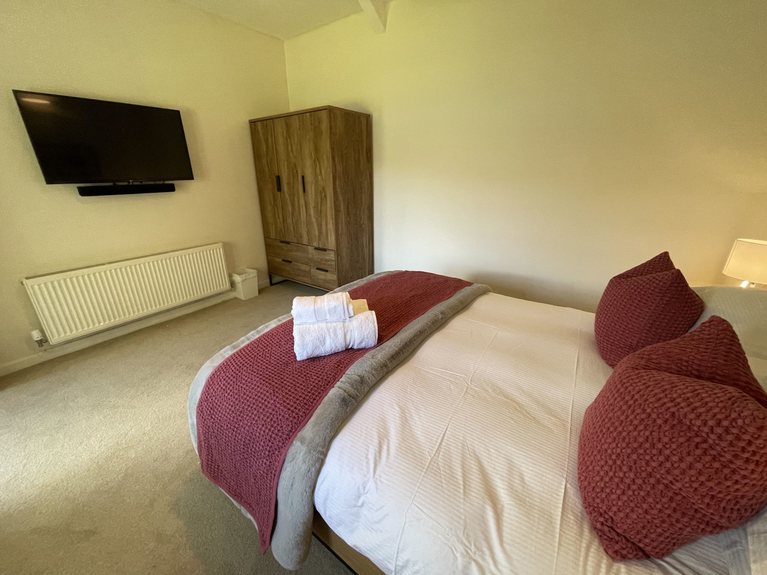The master bedroom features a wall mounted TV 