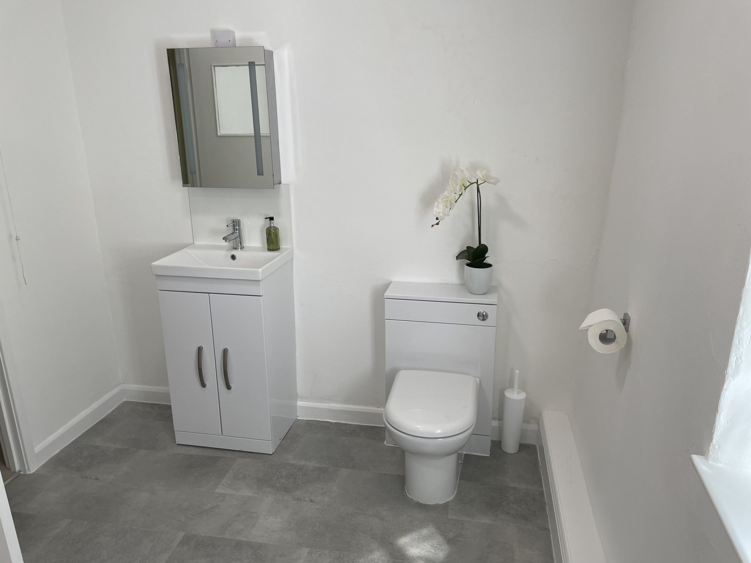 The modern bathroom is spacious and light