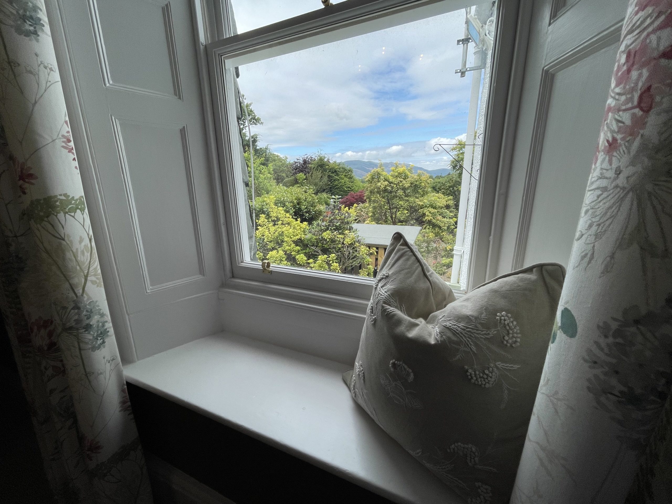 The living room features a gorgeous window seat to soak up the view