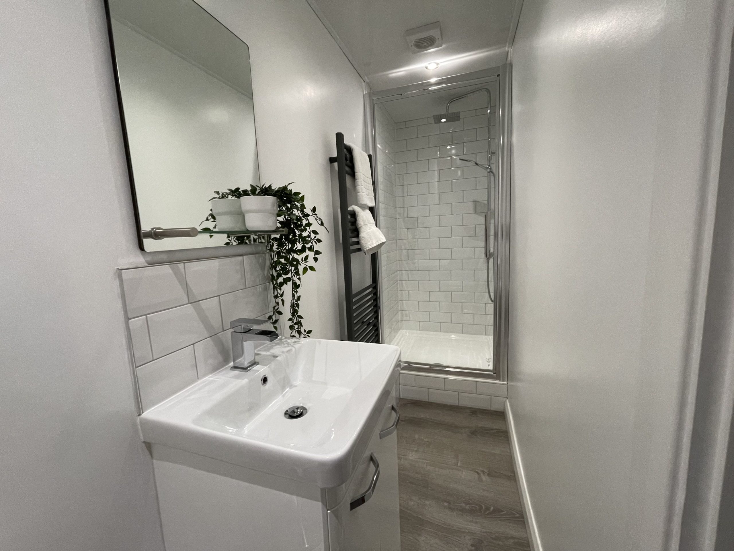 The shower room has a similar style to the family bathroom