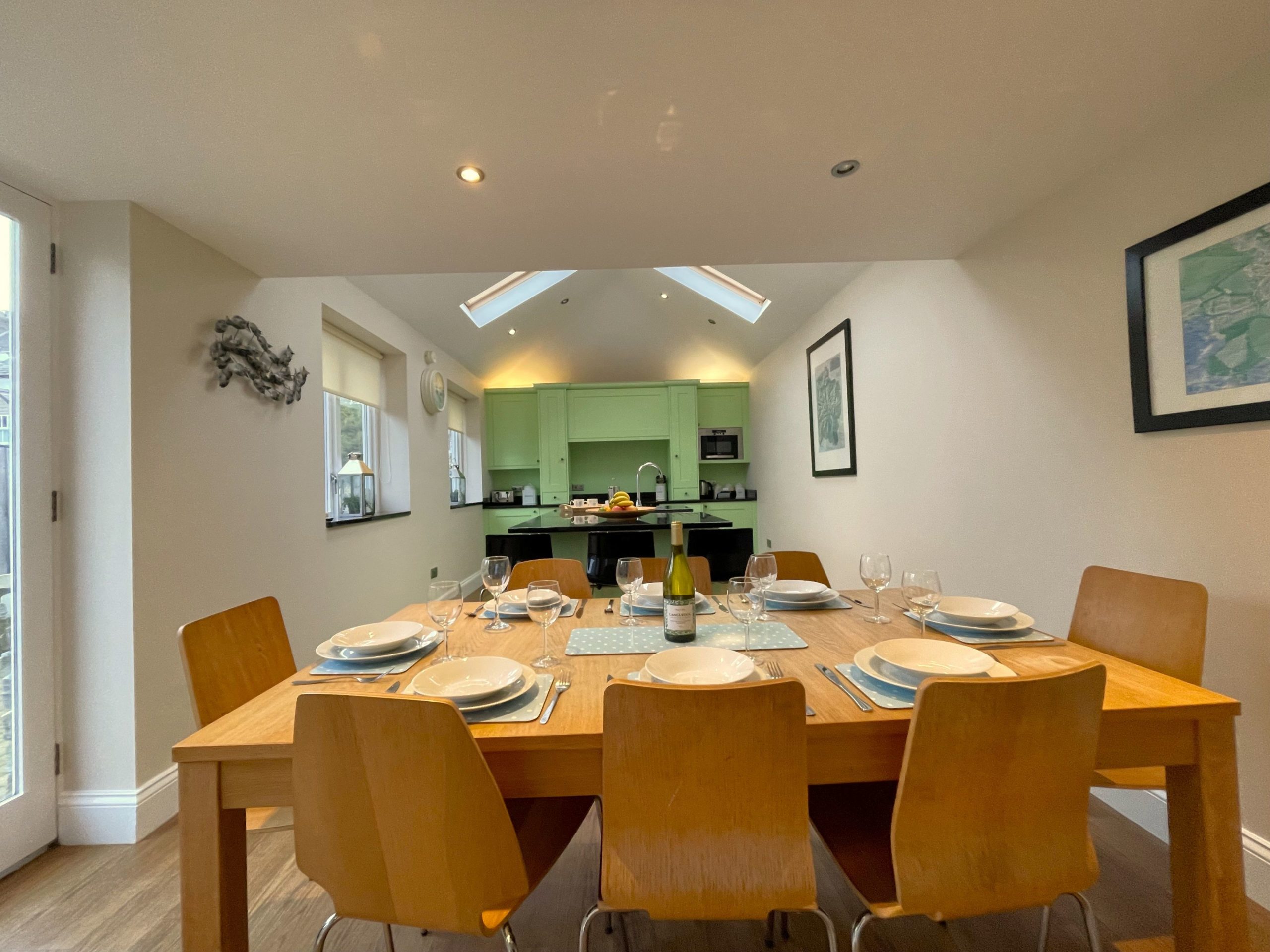 The dining table seats 8 comfortably and there is also a breakfast bar seating 3