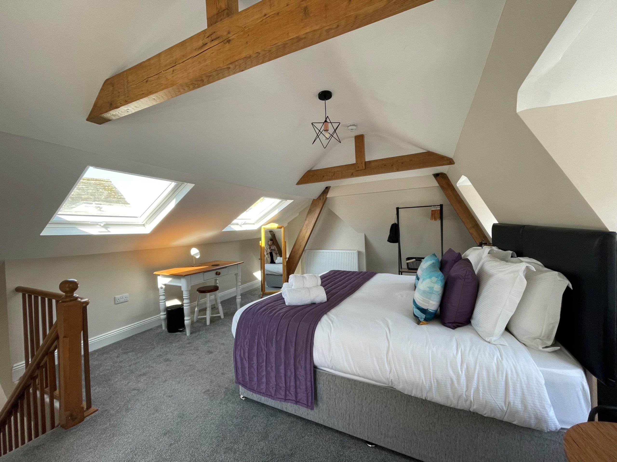 The bedroom is flooded with natural light thanks to the large velux windows.