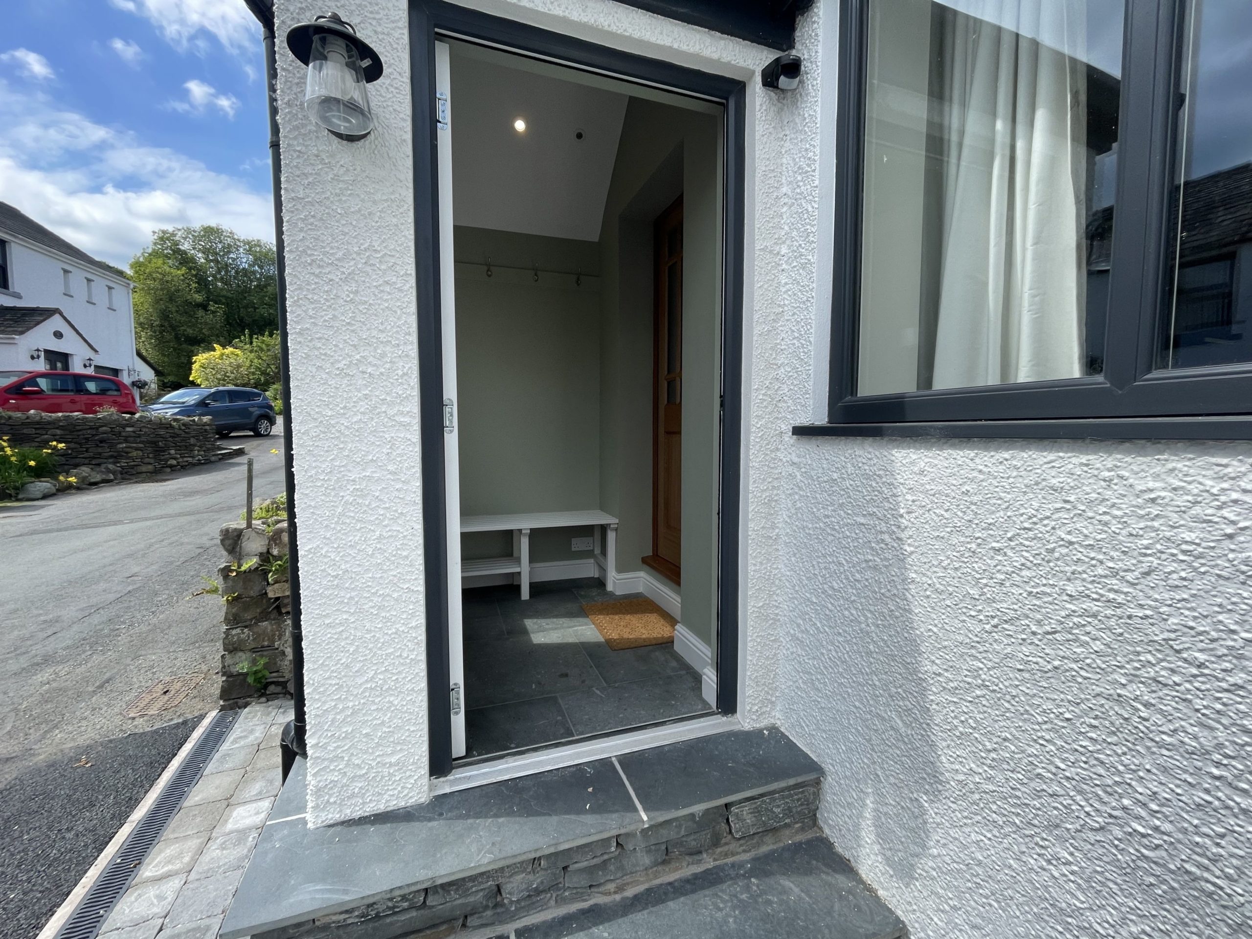 The front door leads into a porch with space for coats and boots