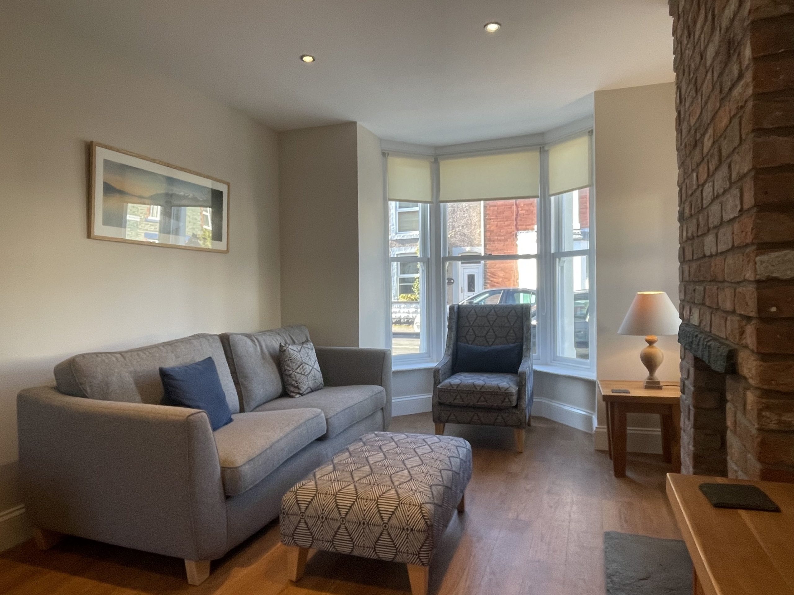 The living room features a log burning stove and bay window