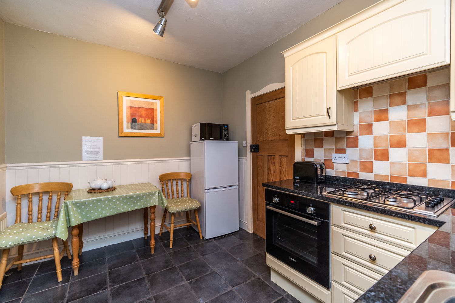 The kitchen has a full sized fridge-freezer